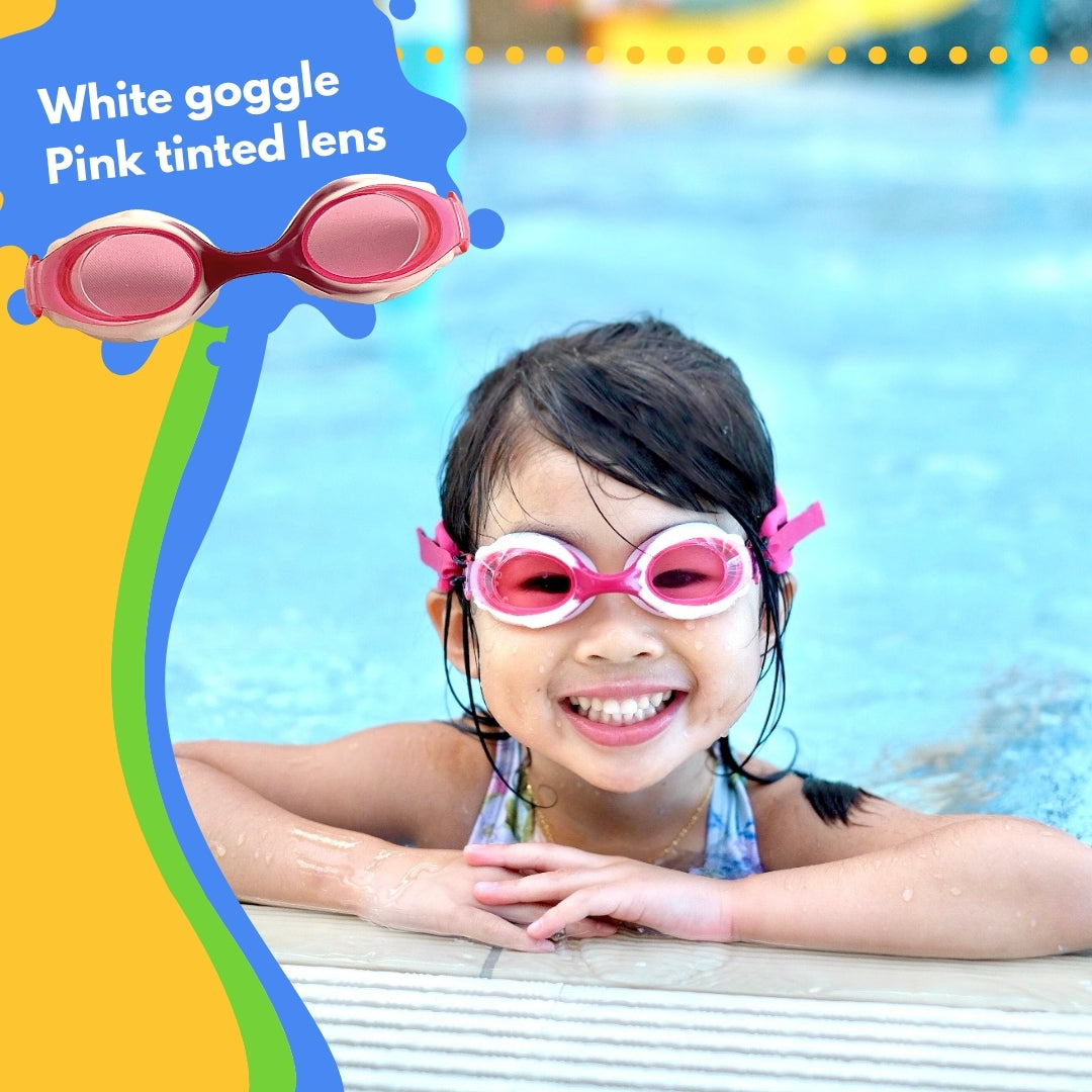 Girl with long dark hair wearing pink Frogglez swim goggles and light blue swimsuit as she stands in a swimming pool. Text reads white goggle with pink tinted lens.