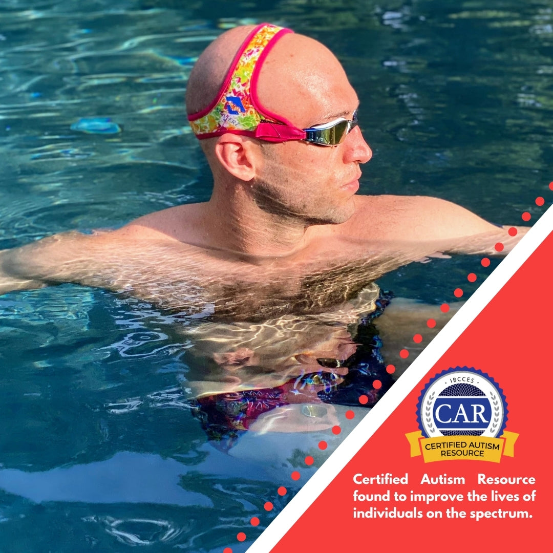 Bald adult man hanging on edge of swimming pool wearing Frogglez Masterz swim goggles. Text reads certified autism resource, found to improve lives of individuals on the spectrum